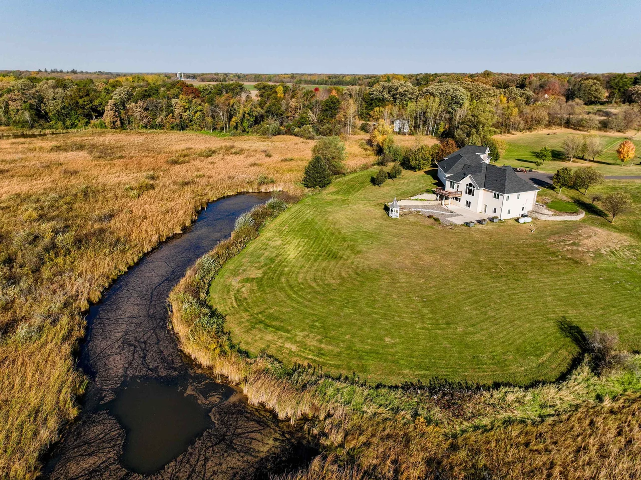 Aerial view of a home and surrounding water.